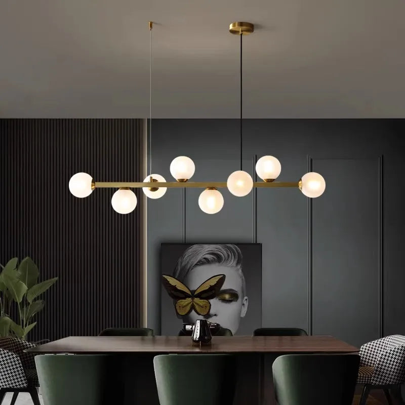 Brown glass shade detail on an iron linear chandelier with LED source