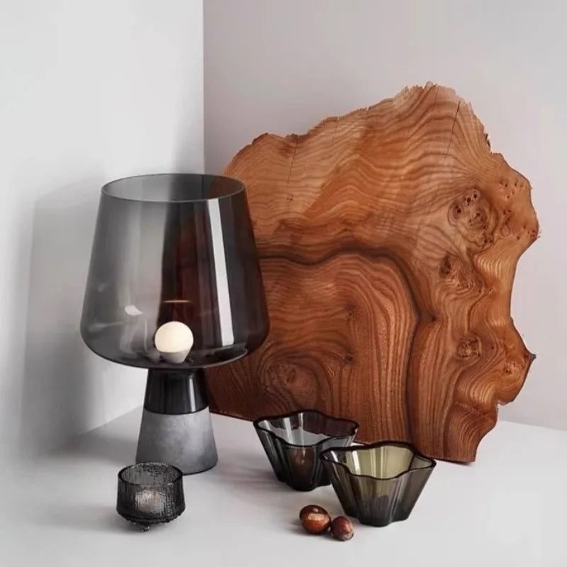 Dark gray glass mood lamp casting minimalist ambient light in bedroom