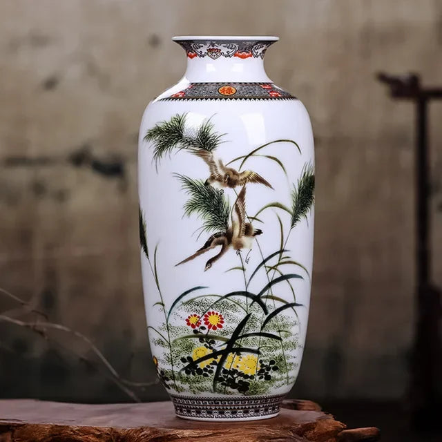 Chinese Jingdezhen ceramic vase with single fresh stem on a dark wood console