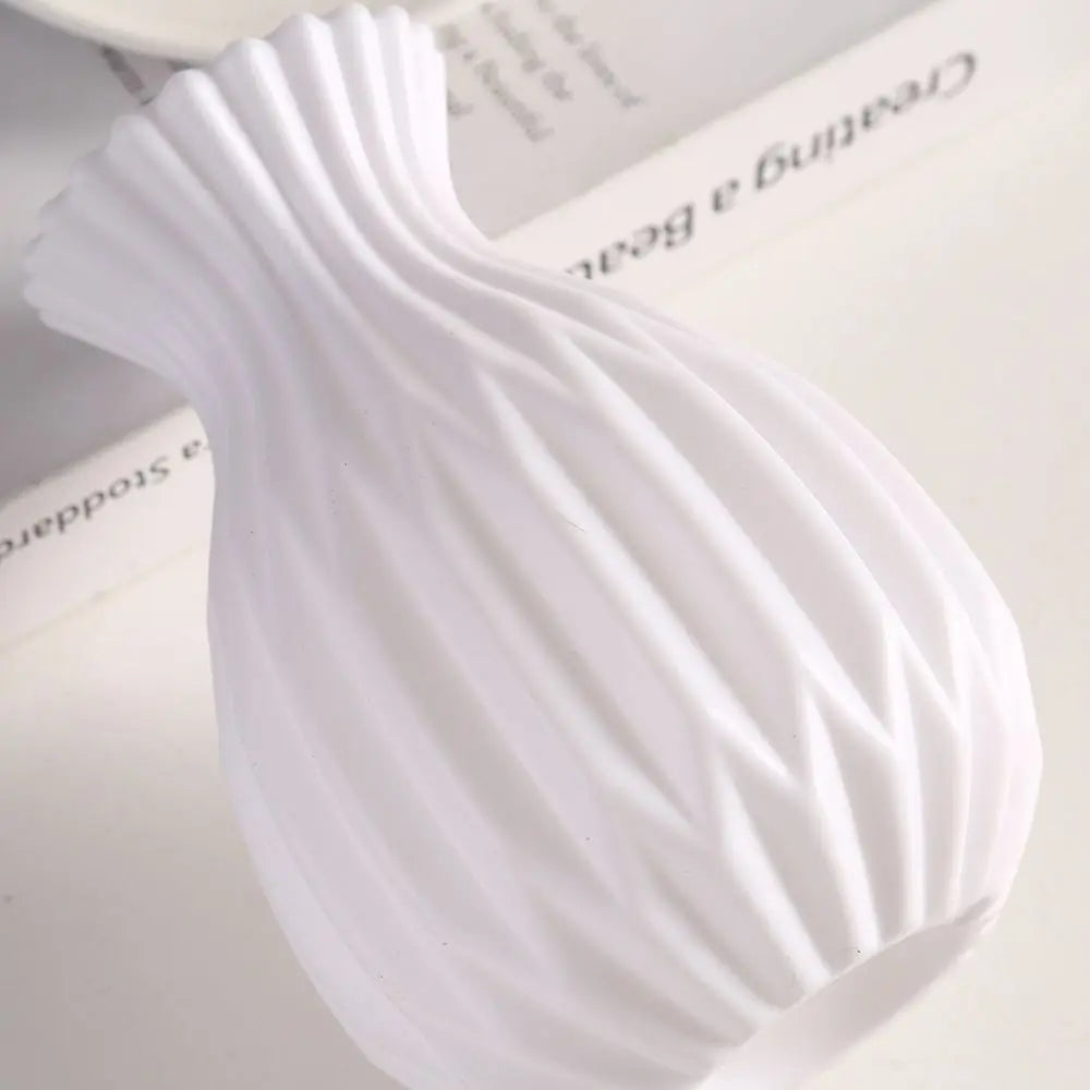 White plastic vase styled with white flowers as a party or event table prop