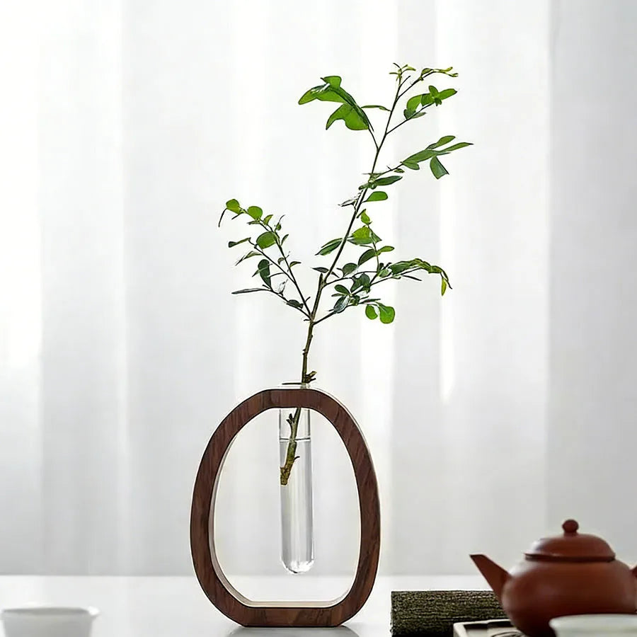 Side profile of walnut wood base vase showing clear glass tube and exposed plant roots
