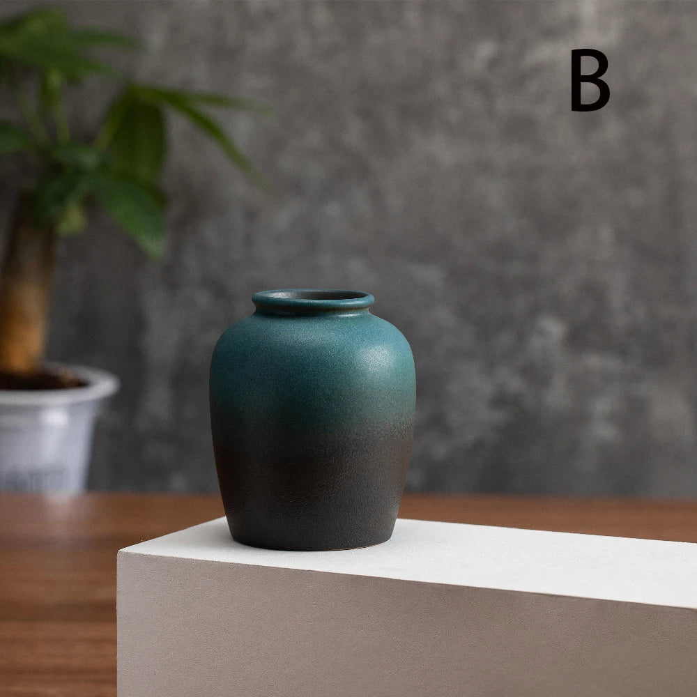 Pair of frosted matte ceramic bud vases in two styles on a grey minimalist shelf