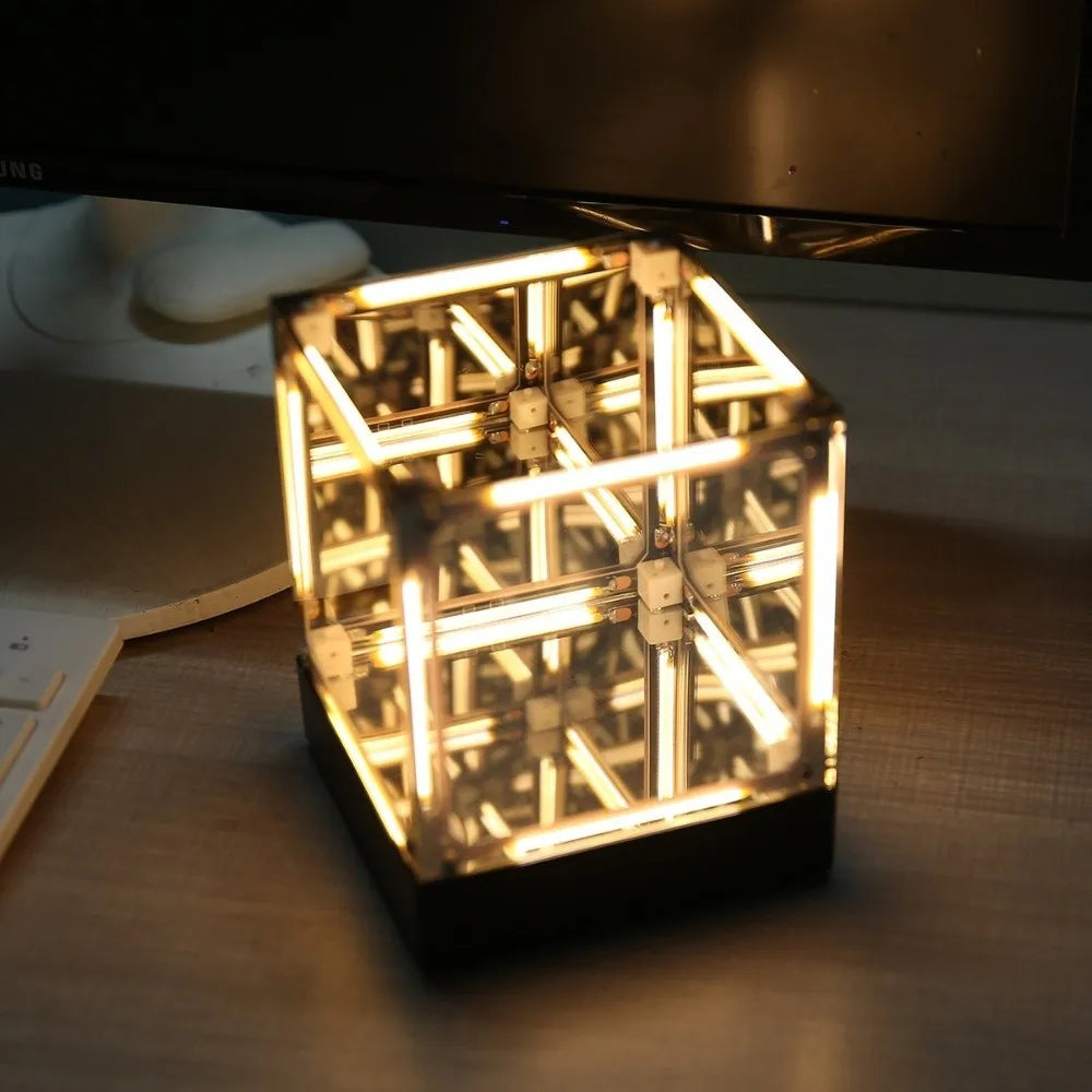 Maglev hypercube lamp base detail showing LED uplight ring beneath cube