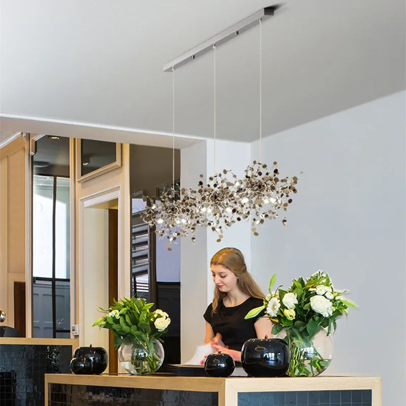 Gold steel chandelier with six heads in a long linear arrangement