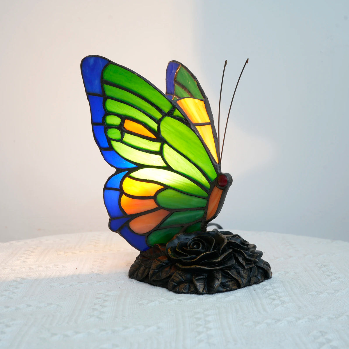 Green butterfly glass lamp close-up showing leaded stained glass detail