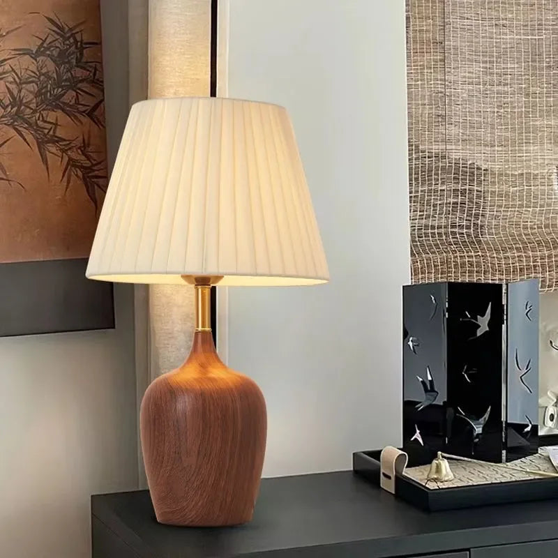 Side profile of walnut vase lamp highlighting organic curved silhouette
