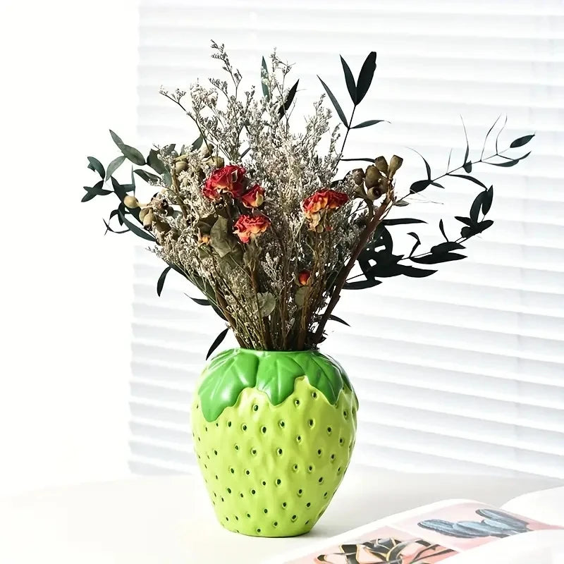 Strawberry shaped ceramic vase group styled in maximalist shelf vignette