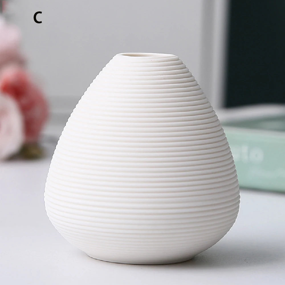 Close-up of base and foot of small black ceramic vase showing clean crafted finish