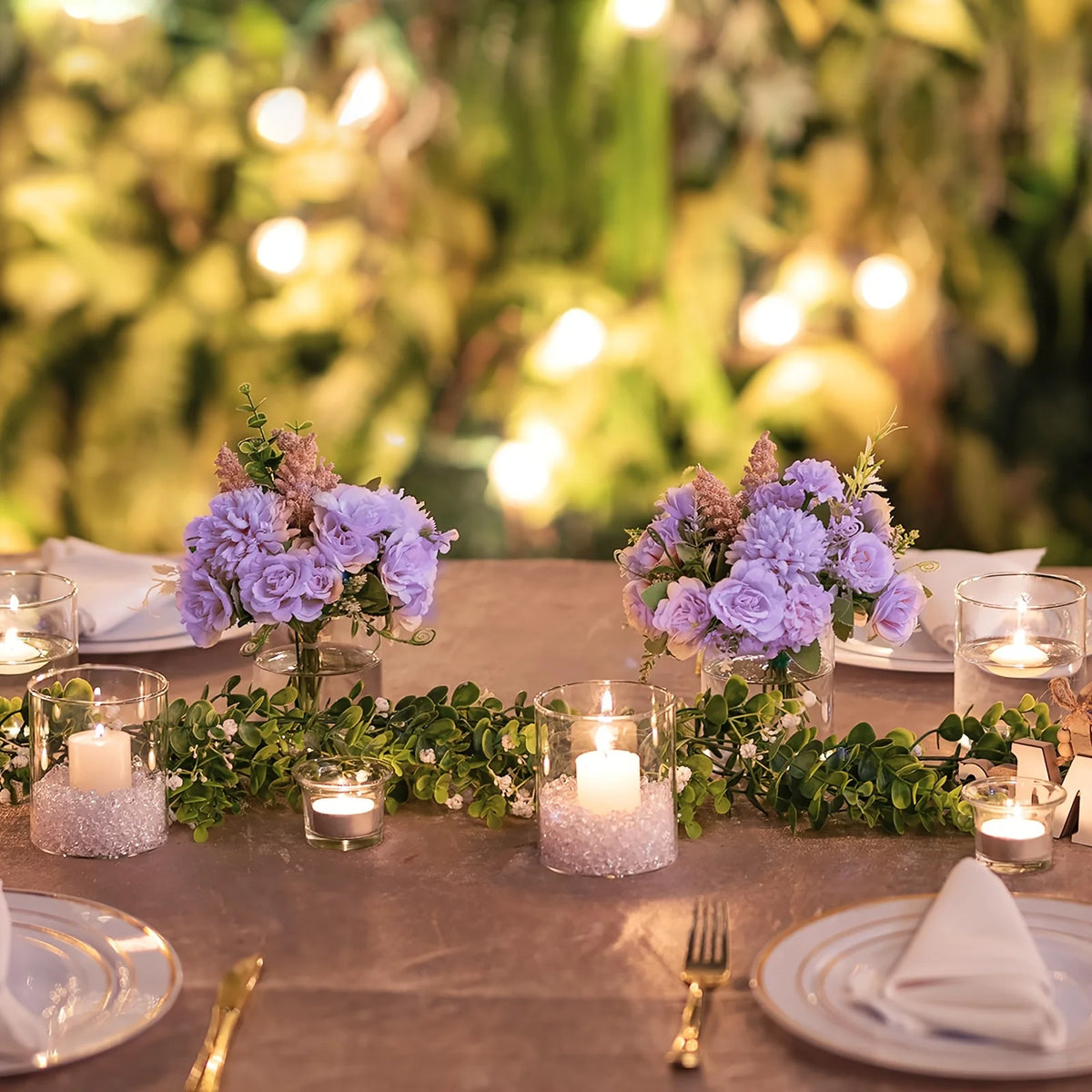 Three acrylic cylinder vases with floating flower petals for event table styling
