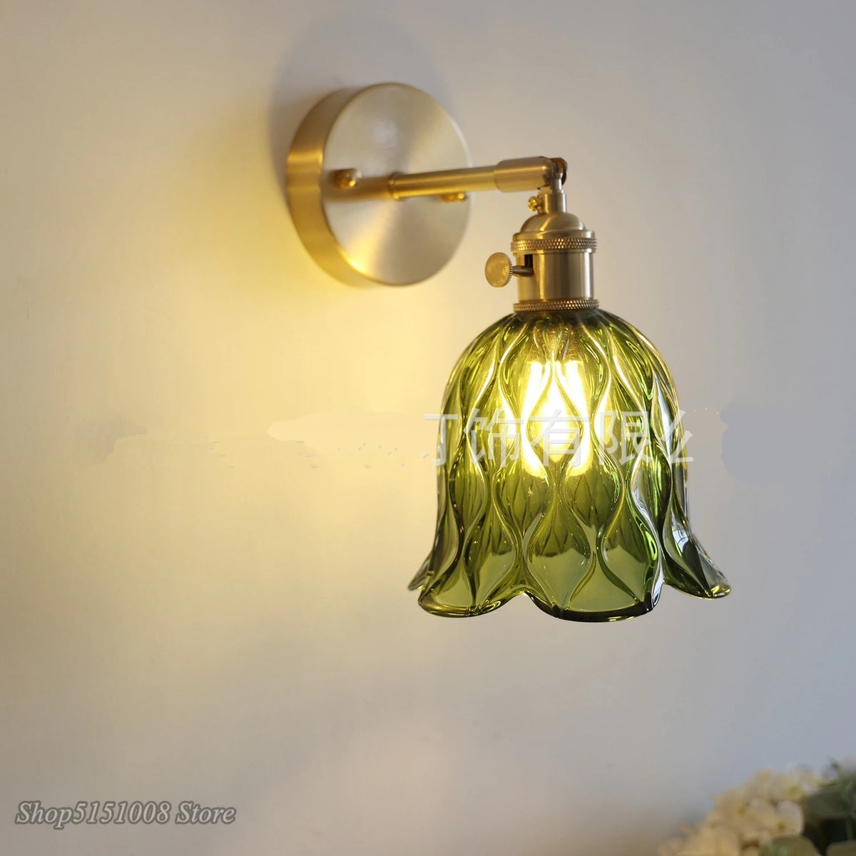 green glass wall sconce, installed in a room interior setting