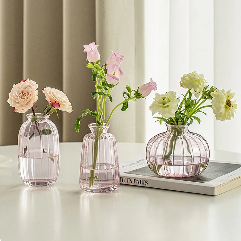 Minimalist clear glass vase with fresh flowers on white table