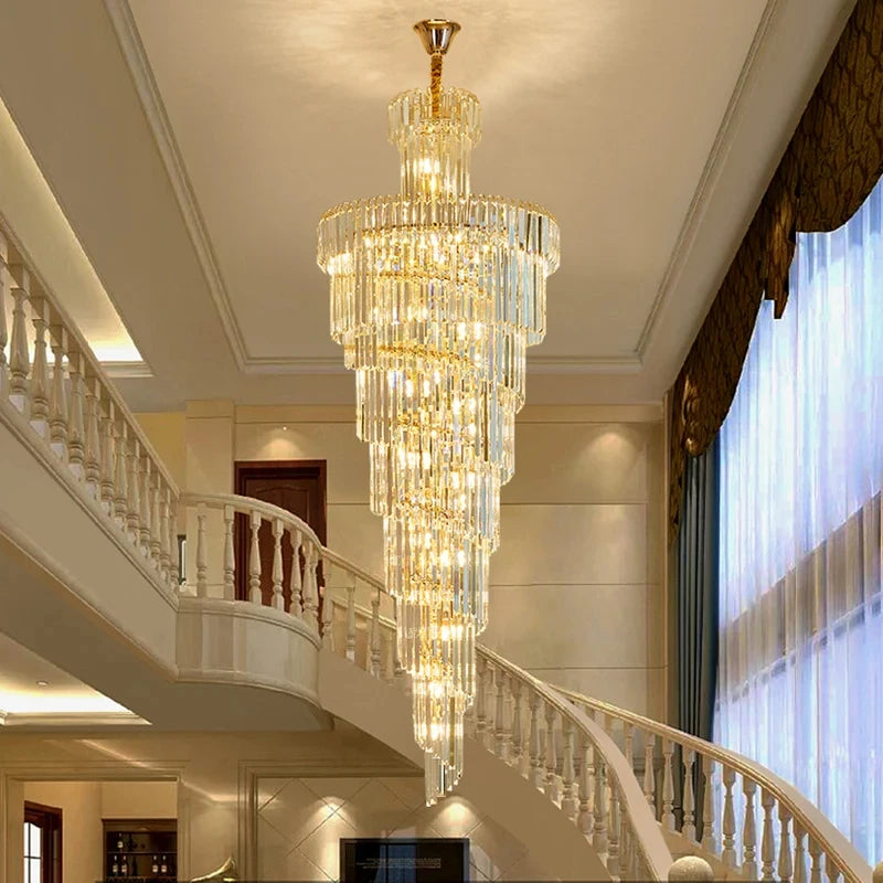 Long crystal staircase chandelier falling as a column from a gold chain mount
