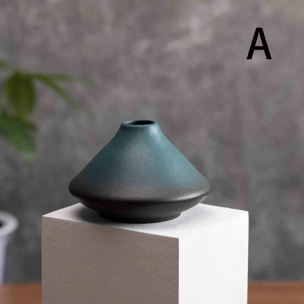 Frosted ceramic vase styled on a bedside table with single fresh white rose stem