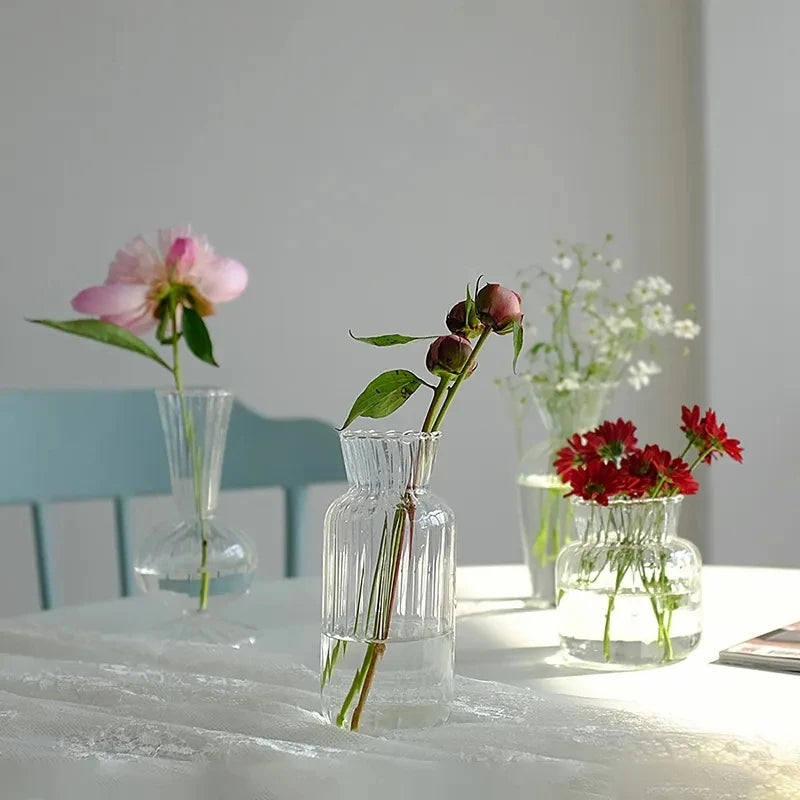 Large Nordic glass bottle vase with dried botanical stems in minimalist interior
