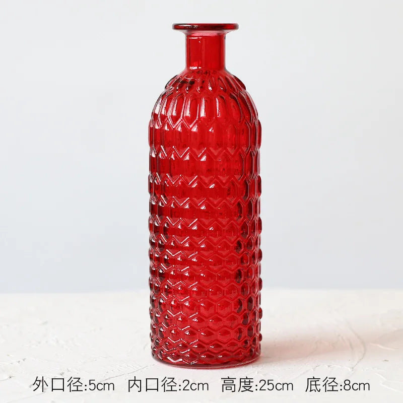 Red and orange glass terrarium vases grouped as eclectic shelf styling
