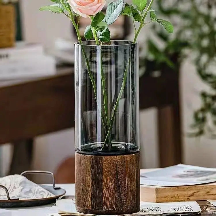 Five style glass bud vases with wooden bases arranged as a collection display