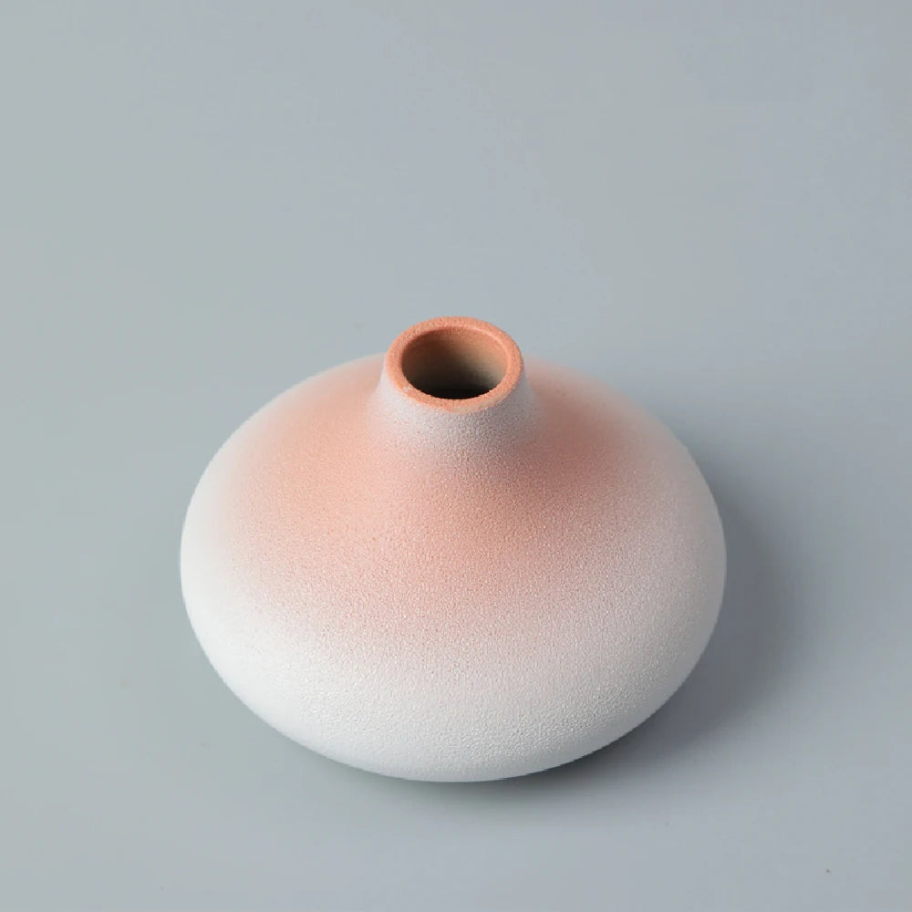 Japanese matte black ceramic vase with dried eucalyptus on wooden shelf