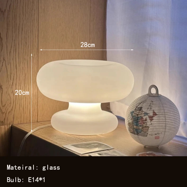 Art Deco glass table lamp in a modern living room setting with warm ambient light