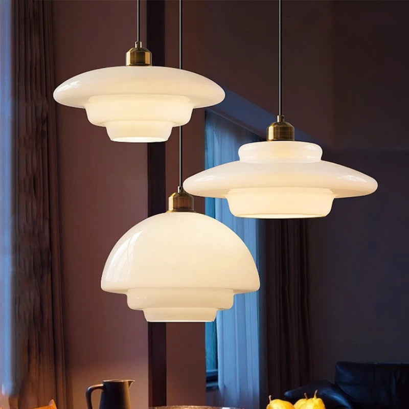 Cream milk glass chandelier with an opal shade glowing evenly