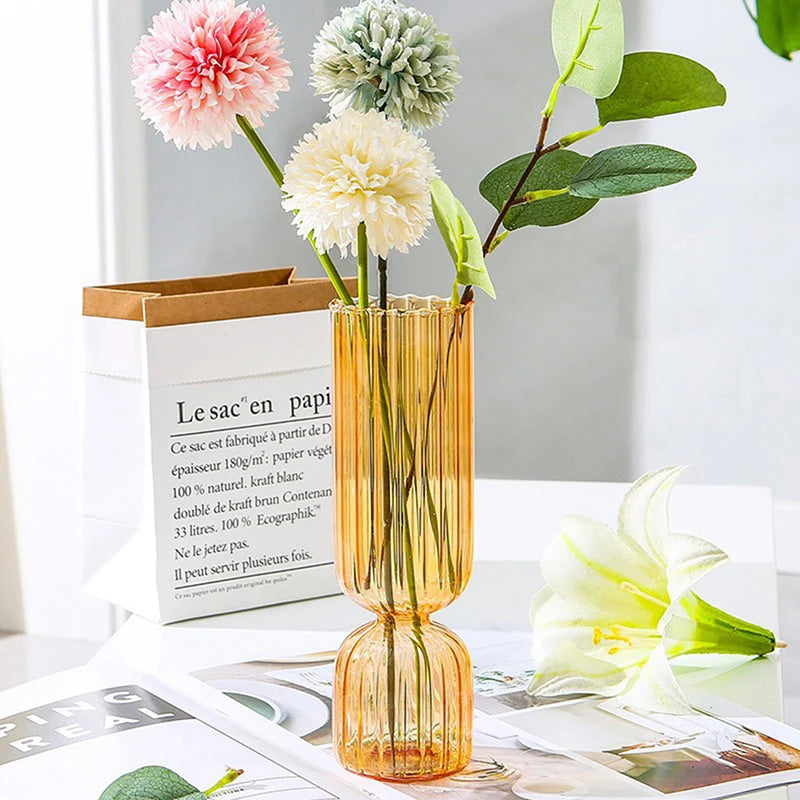 Green glass globe vase styled with tropical leaves in Scandi living room interior