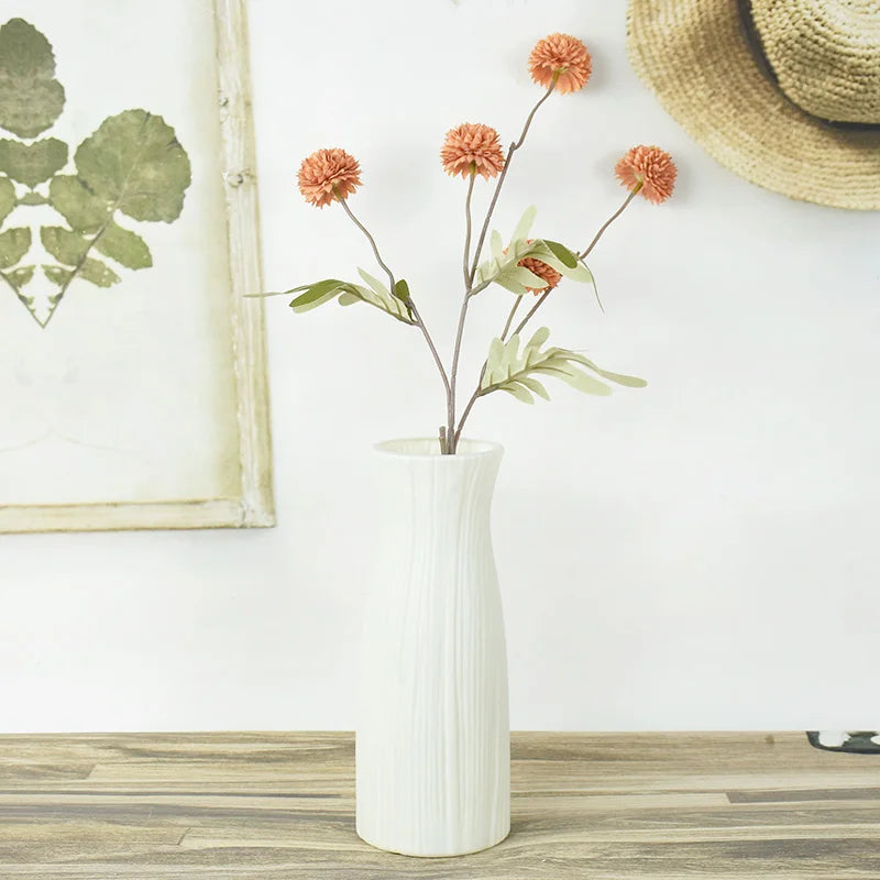 Close-up of smooth matte white plastic finish on Nordic-style round indoor flower pot