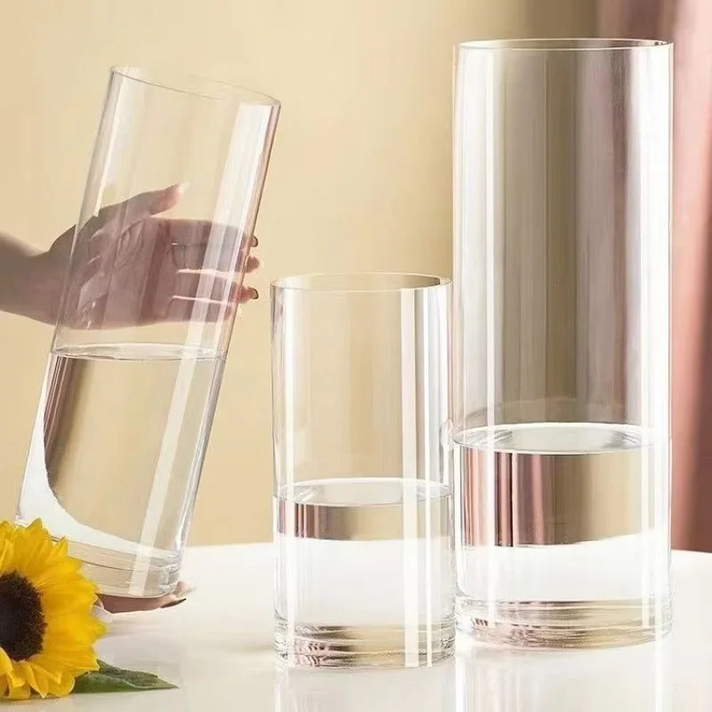 Clear acrylic cylinder vase in 12x30cm with white flower arrangement inside