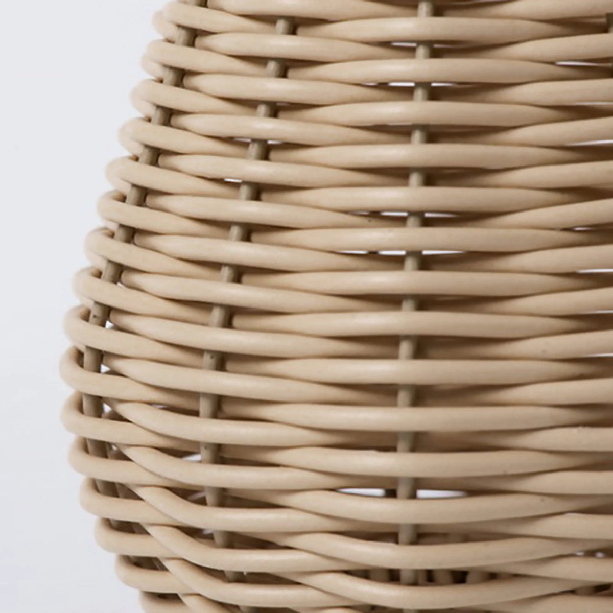 Close-up of textured plastic rattan weave surface detail on handwoven flower vase
