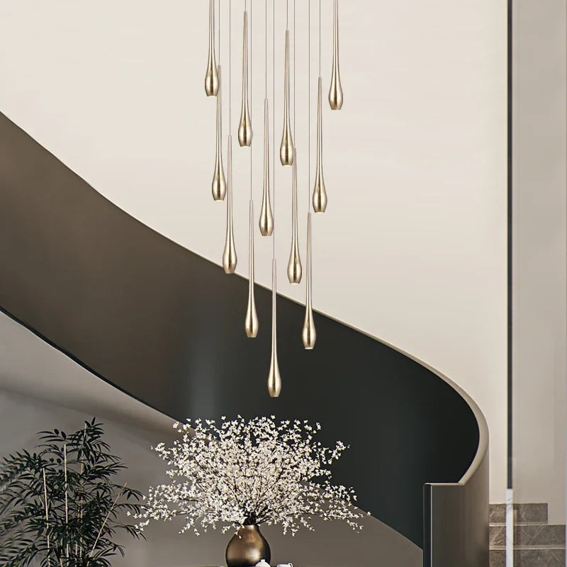 Gold plated chandelier arms at staggered heights forming a long line