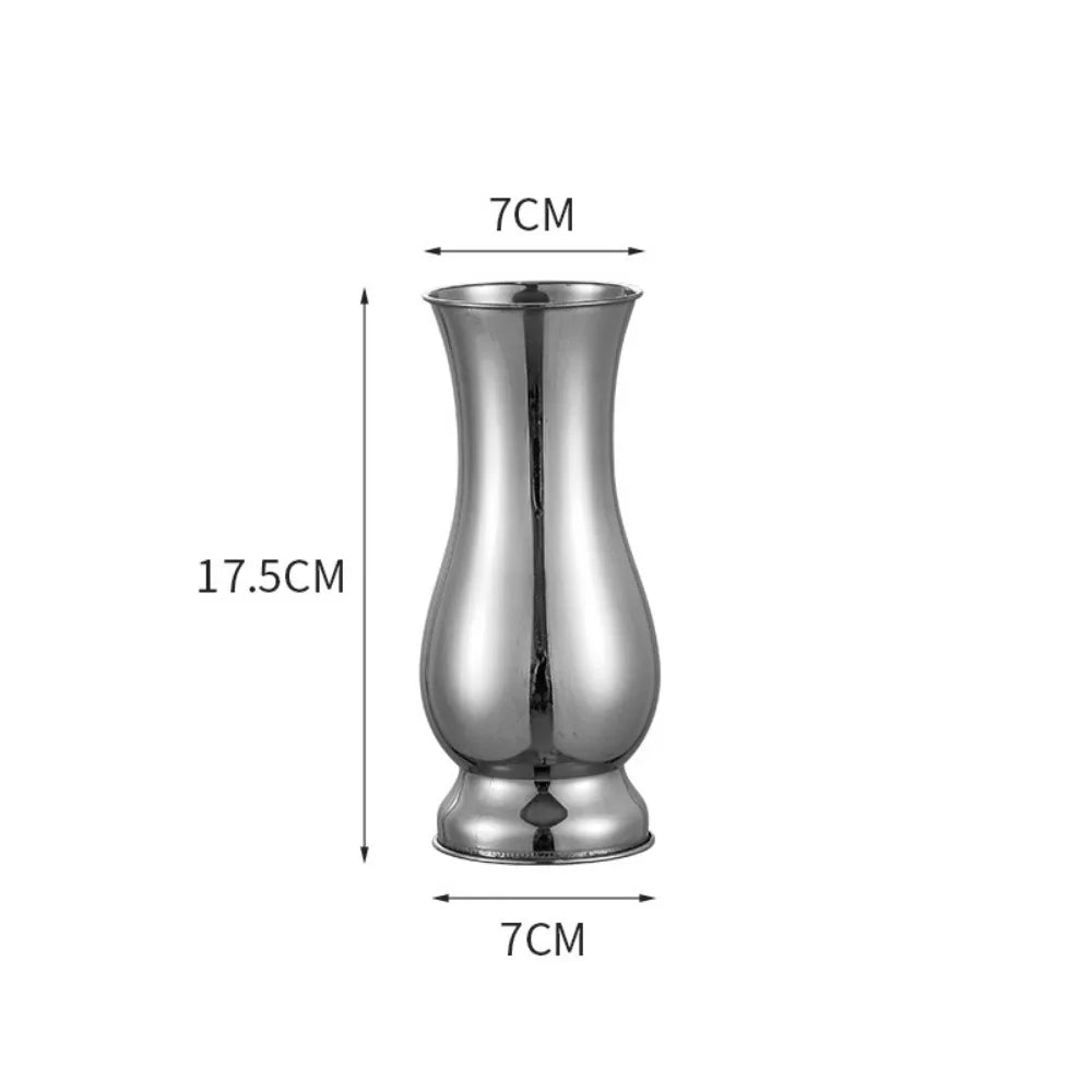 Silver single stem vase with dried eucalyptus branch on wooden console