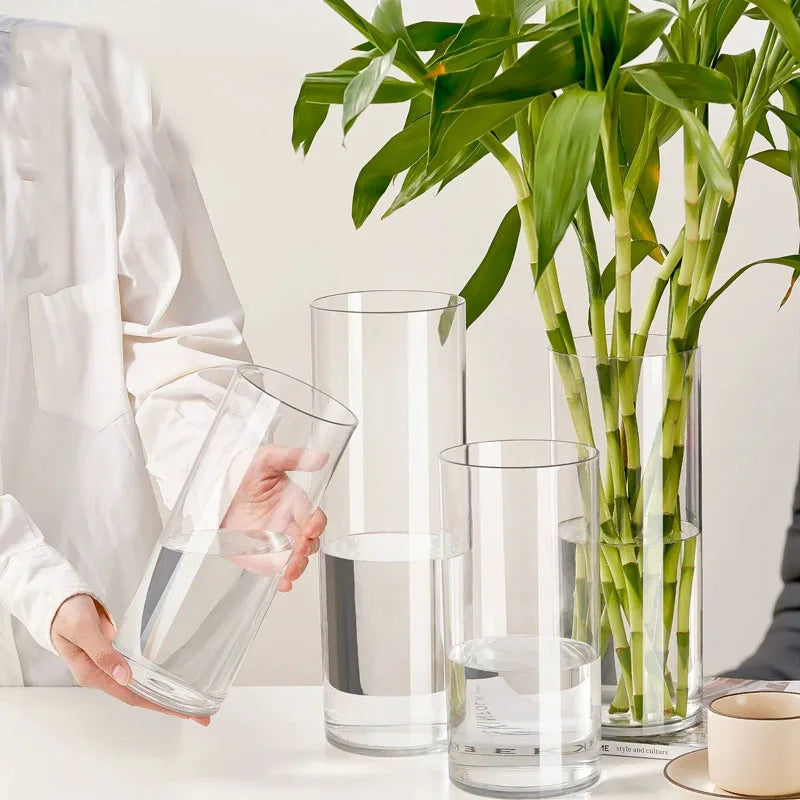 Small 20cm clear acrylic vase with fresh mixed flowers on desk