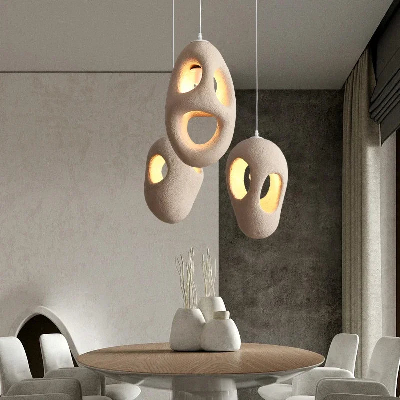 Matte white resin chandelier releasing a warm glare free downward glow