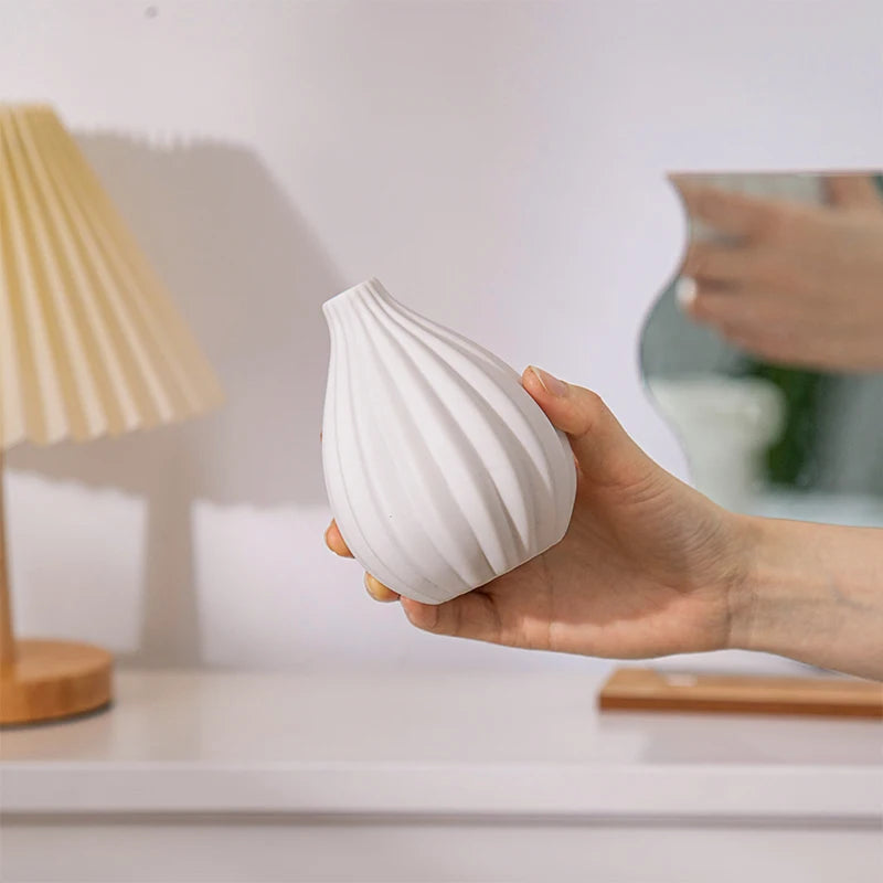 Close-up of white Nordic ceramic vase surface matte texture