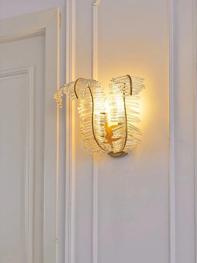 Feather crystal chandelier lit in warm light over a dining table