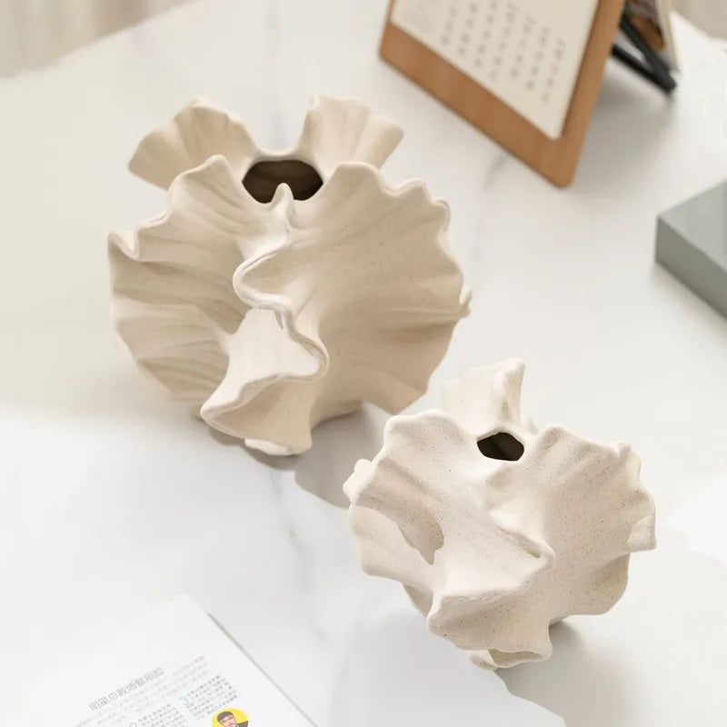 White ceramic petal vase styled in modern living room interior