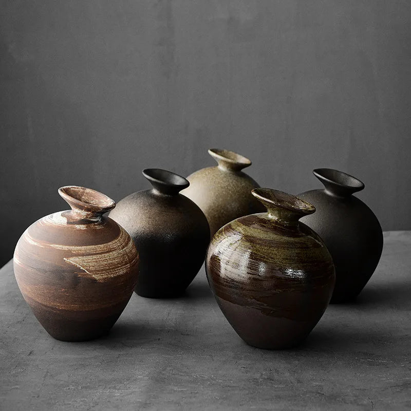 Rustic rough ceramic zen vase with flower on wooden table