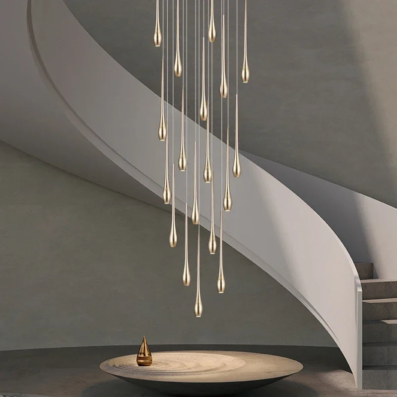 Gold plated staircase chandelier with gilded arms stepping down a void