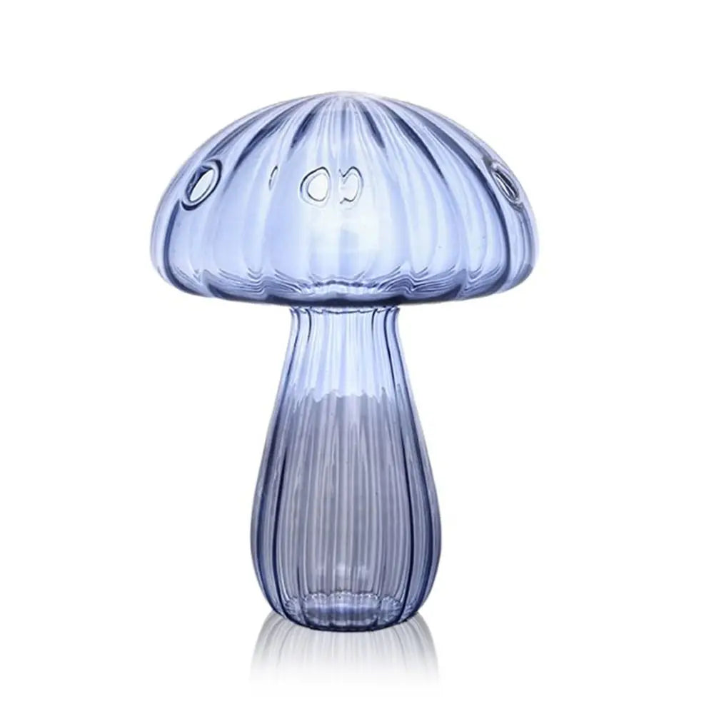 Yellow mushroom glass vase in overhead flat lay on white marble surface