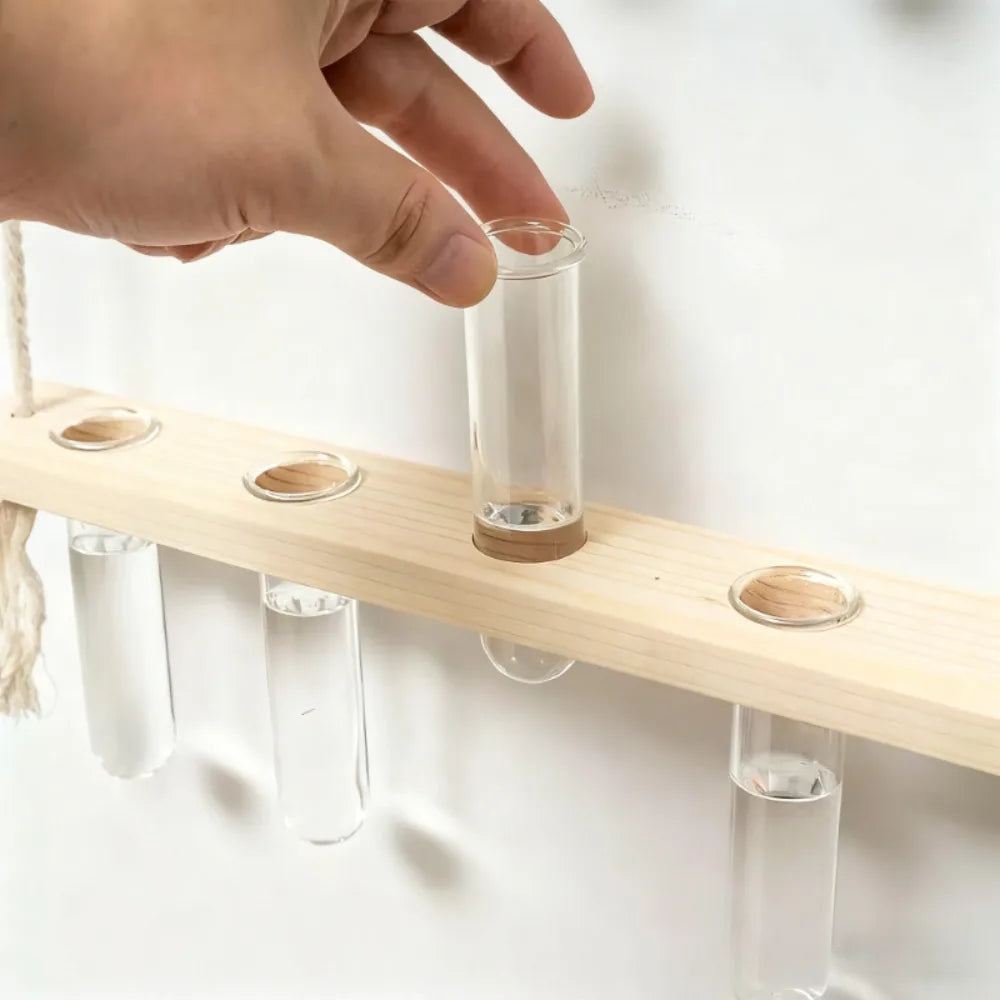 Glass test tube wall vase B-2 mounted on a Scandi bedroom wall with green herbs