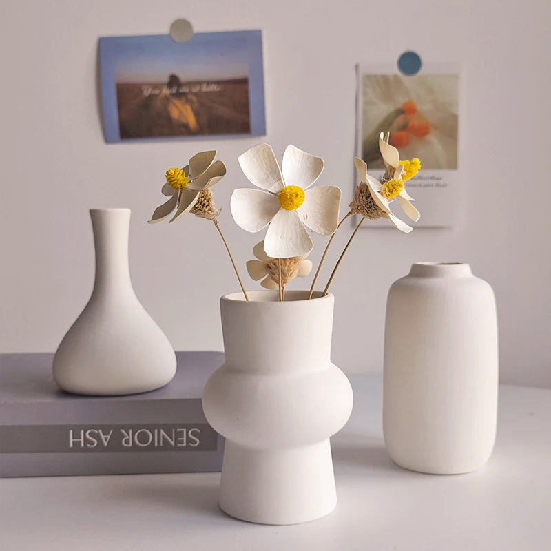 Minimalist white ceramic vase styled in Scandinavian interior