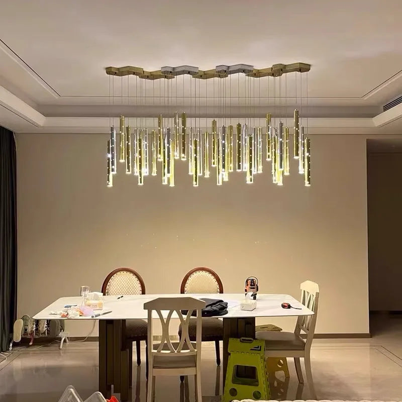 Hollowed metal tube chandelier with slim plated tubes at staggered lengths