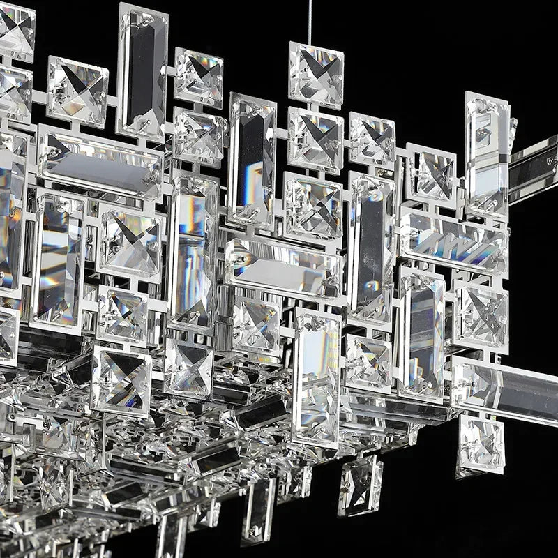 Polished steel and crystal chandelier hung on adjustable cord pendants