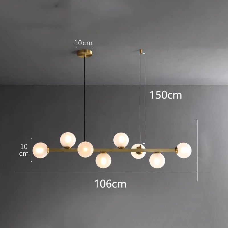 Linear iron chandelier with glass shades shown unlit against a wall