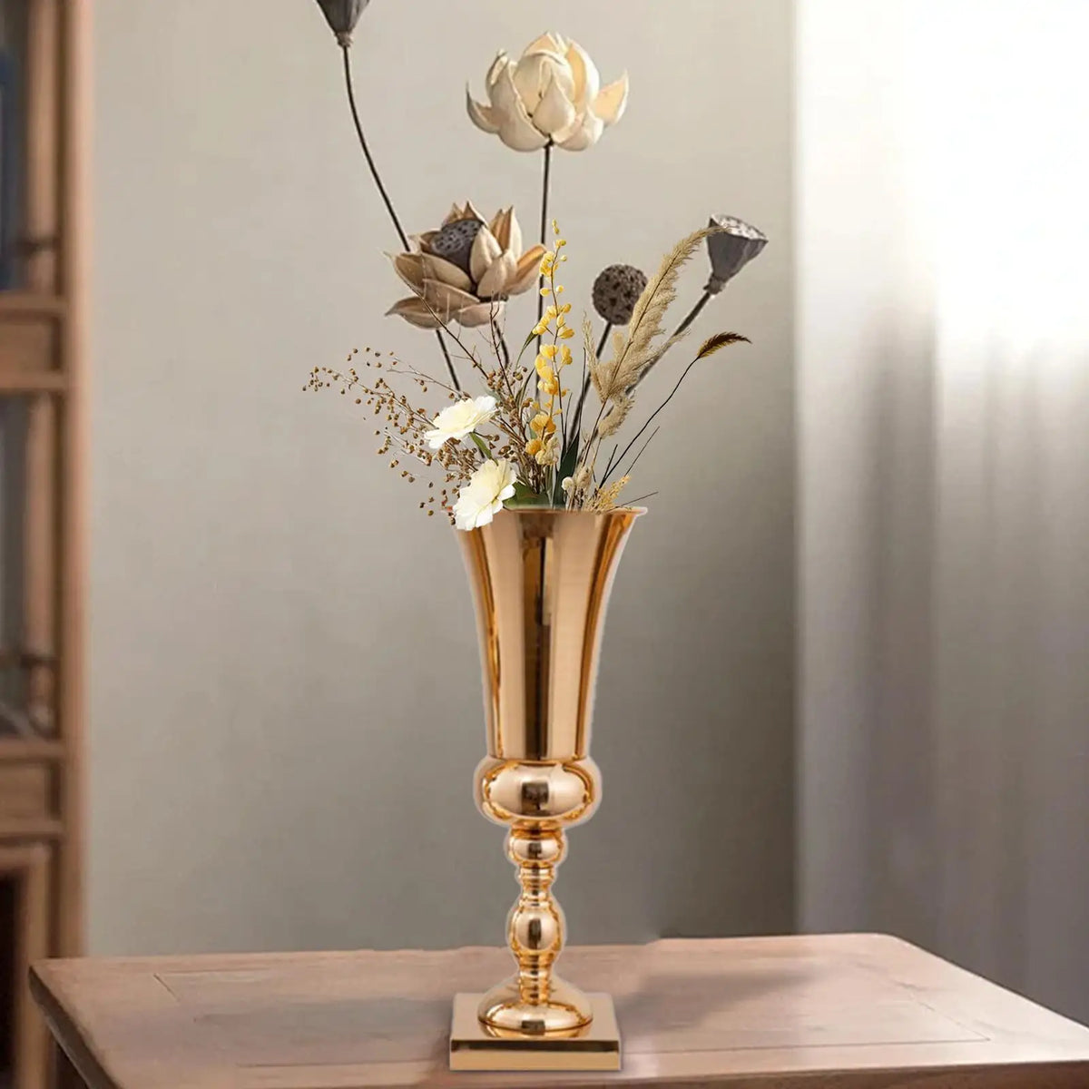 Wedding reception table styled with gold metal flower stand vases in a row