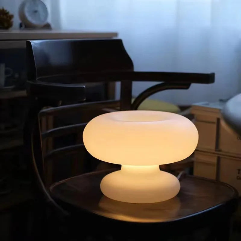 Art Deco glass LED table lamp styled on a bedroom bedside table