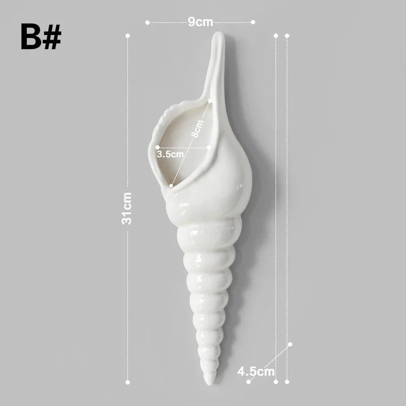 Paired ceramic conch wall vases in different orientations on pastel wall