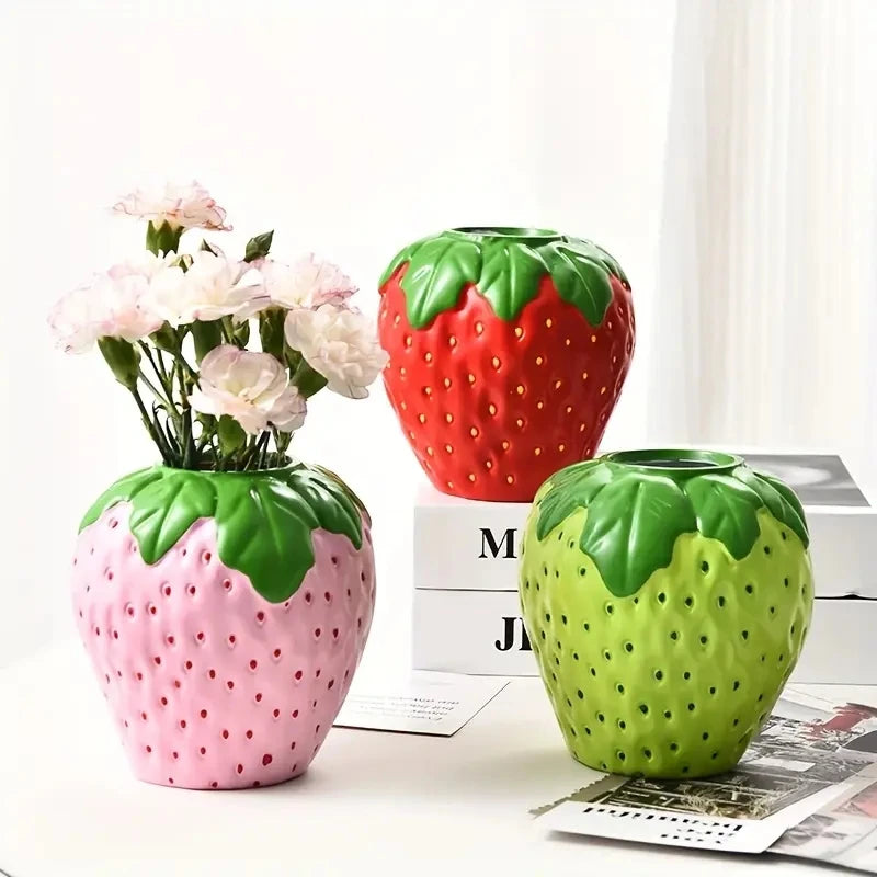 Red ceramic strawberry vase as cottagecore bedroom accent on shelf