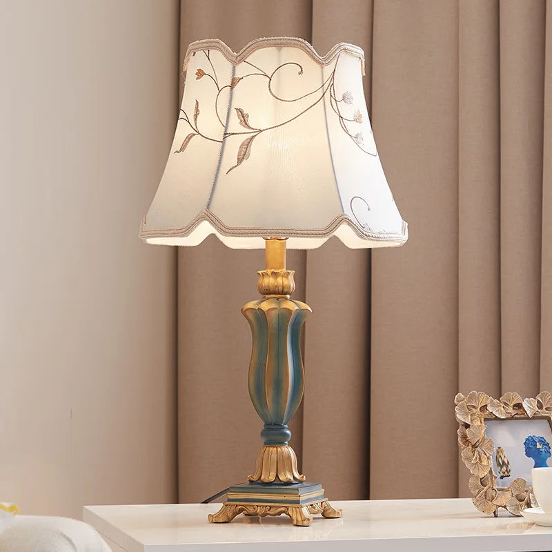 Country fabric table lamp UK plug variant switched off on wooden nightstand