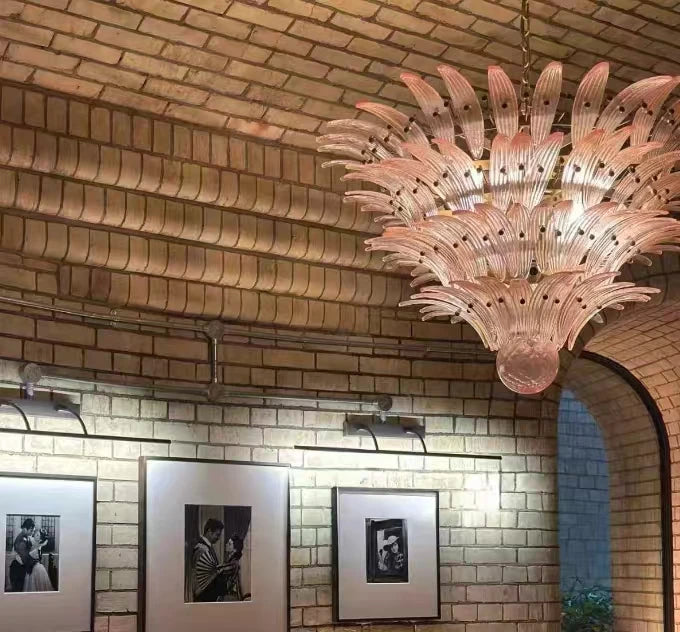 Clear glass chandelier shades lit by G9 LED bulbs in warm light