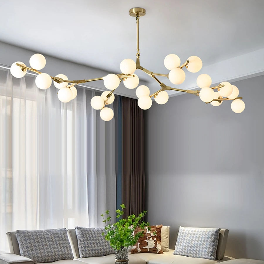 Golden iron branch chandelier with frosted glass shade heads