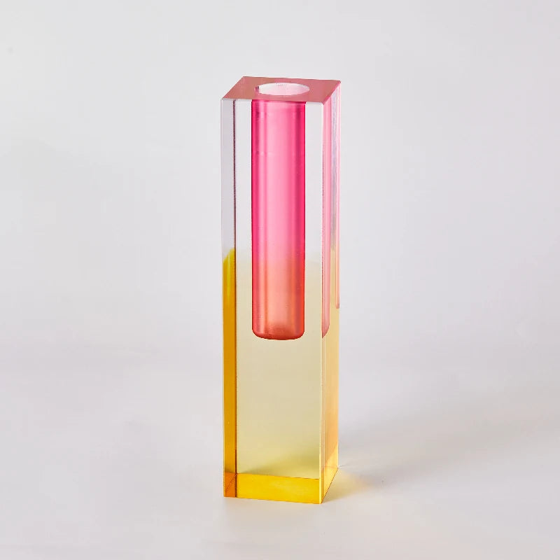 Blue frosted tall acrylic pillar bud vase with dried grasses on a sideboard